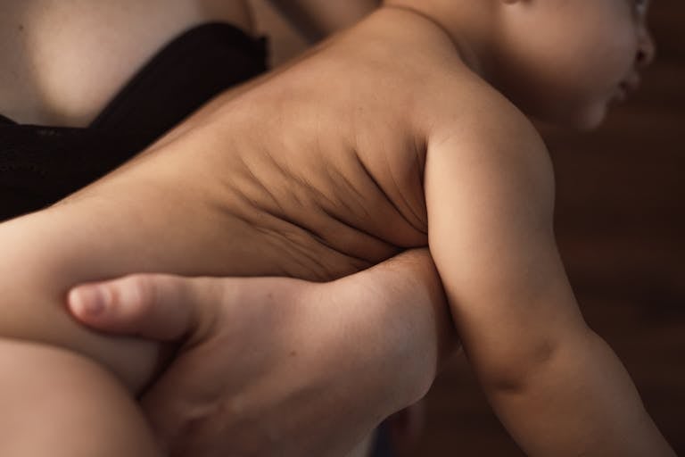 A tender close-up of a mother holding her baby, showcasing warmth and affection.