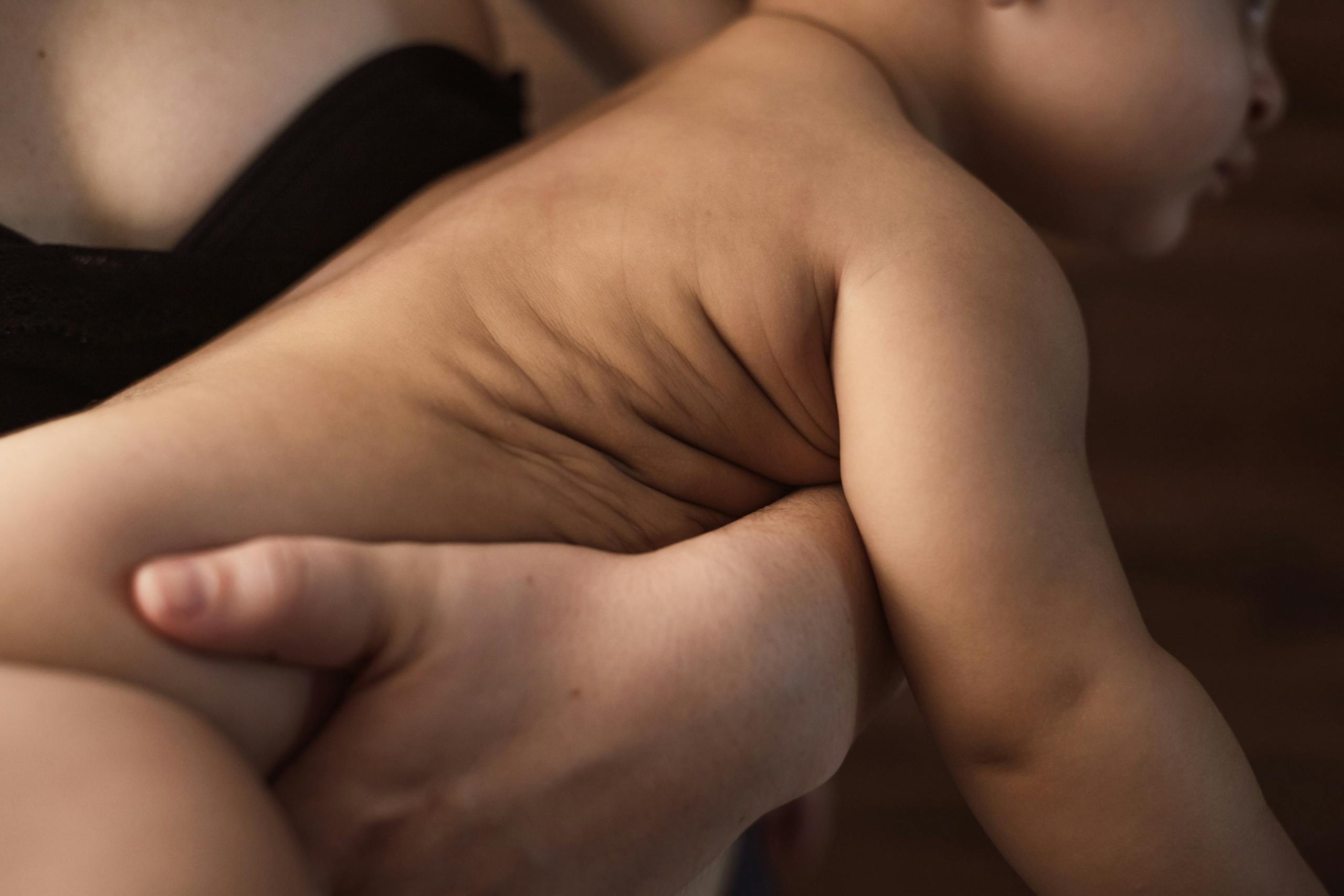 A tender close-up of a mother holding her baby, showcasing warmth and affection.